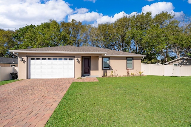 single story home with an attached garage, decorative driveway, a front yard, and stucco siding