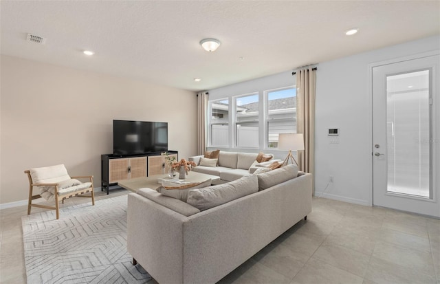 living room featuring visible vents, baseboards, and recessed lighting