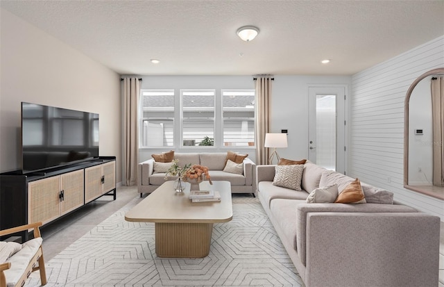 living area featuring a textured ceiling and recessed lighting