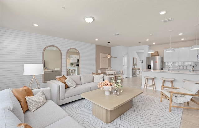 living room with recessed lighting and light tile patterned floors