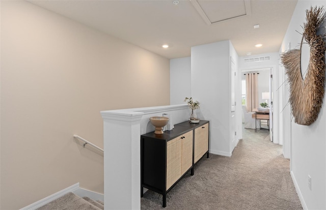 corridor featuring carpet, recessed lighting, visible vents, an upstairs landing, and baseboards