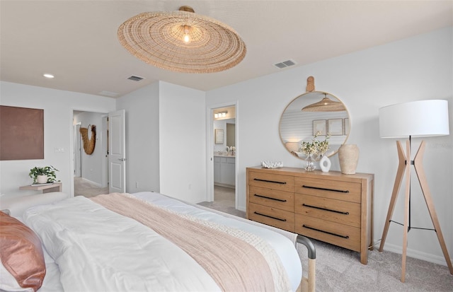 bedroom featuring light carpet, ensuite bathroom, visible vents, and baseboards