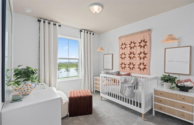 carpeted bedroom featuring a crib