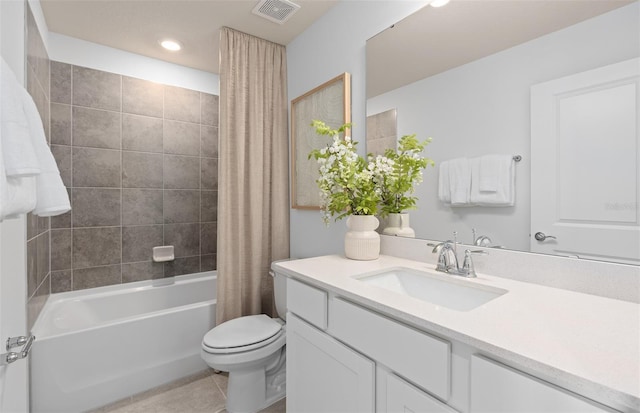 bathroom featuring visible vents, toilet, tile patterned floors, shower / bath combo with shower curtain, and vanity