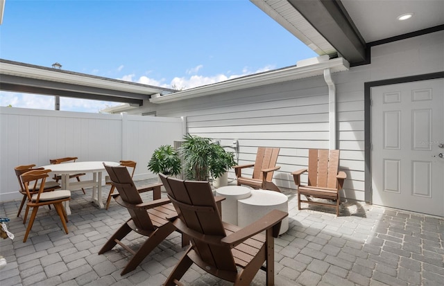 view of patio with outdoor dining area and fence