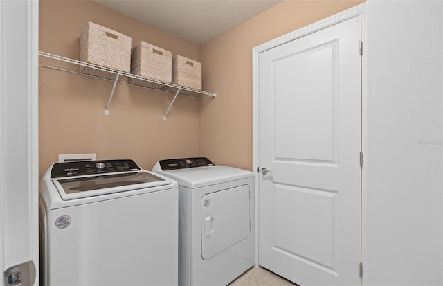 washroom featuring laundry area and washing machine and clothes dryer