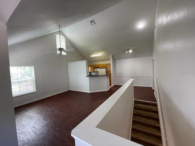 stairs featuring visible vents, baseboards, a ceiling fan, and wood finished floors