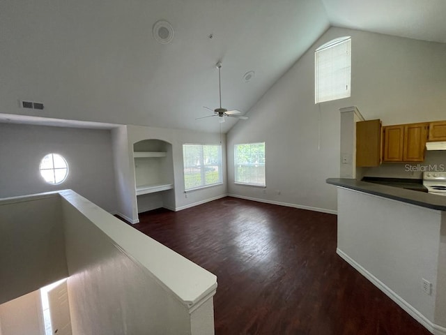 unfurnished living room with visible vents, baseboards, ceiling fan, dark wood finished floors, and high vaulted ceiling