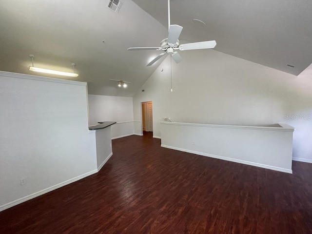 unfurnished living room with visible vents, a ceiling fan, wood finished floors, baseboards, and lofted ceiling