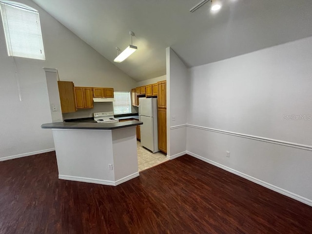 kitchen with under cabinet range hood, white appliances, dark countertops, and light wood-style floors