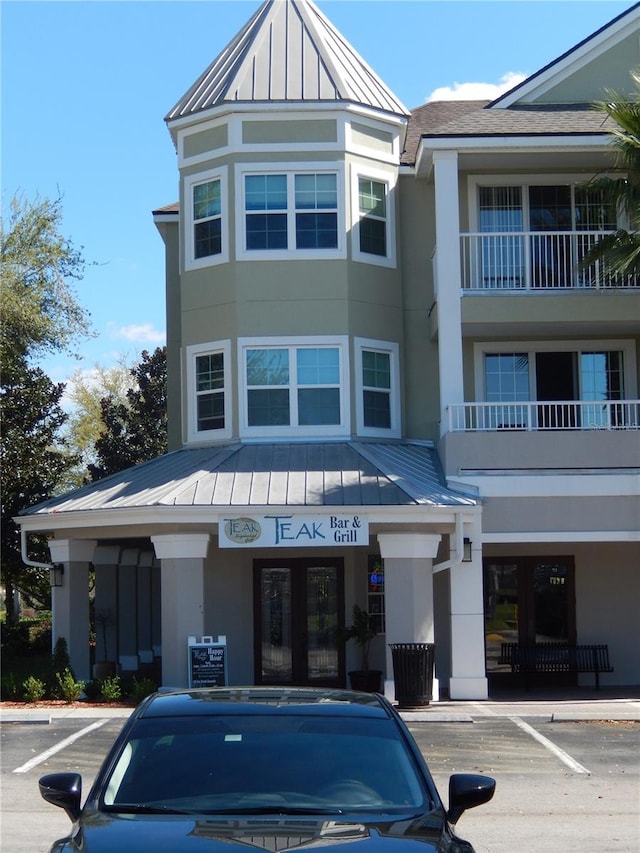 view of building exterior with uncovered parking