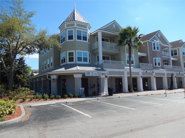 view of building exterior with uncovered parking