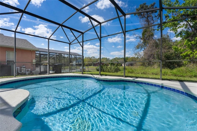 pool with a lanai and a patio area