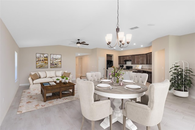 dining area with light wood-style flooring, visible vents, recessed lighting, lofted ceiling, and ceiling fan with notable chandelier