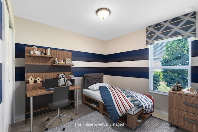 bedroom featuring baseboards and carpet