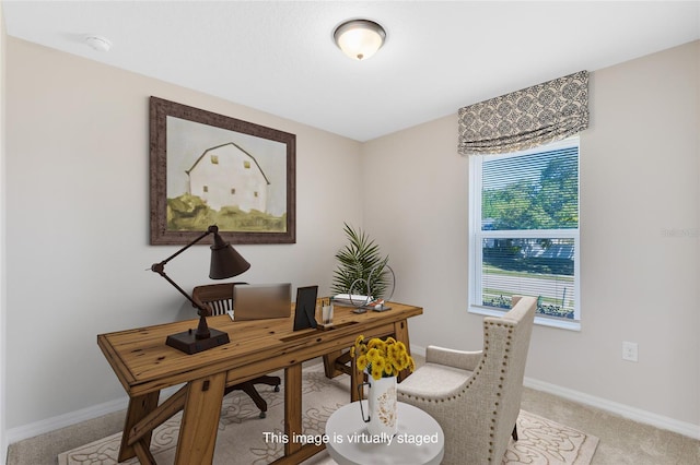 home office with baseboards and light colored carpet