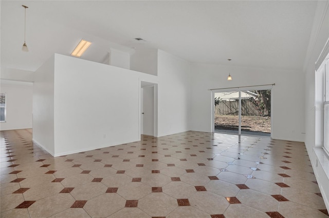 spare room featuring high vaulted ceiling, light tile patterned flooring, and baseboards