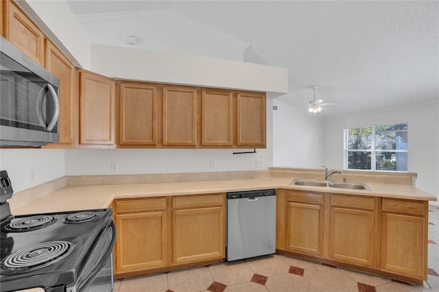 kitchen with stainless steel appliances, a peninsula, a sink, a ceiling fan, and light countertops