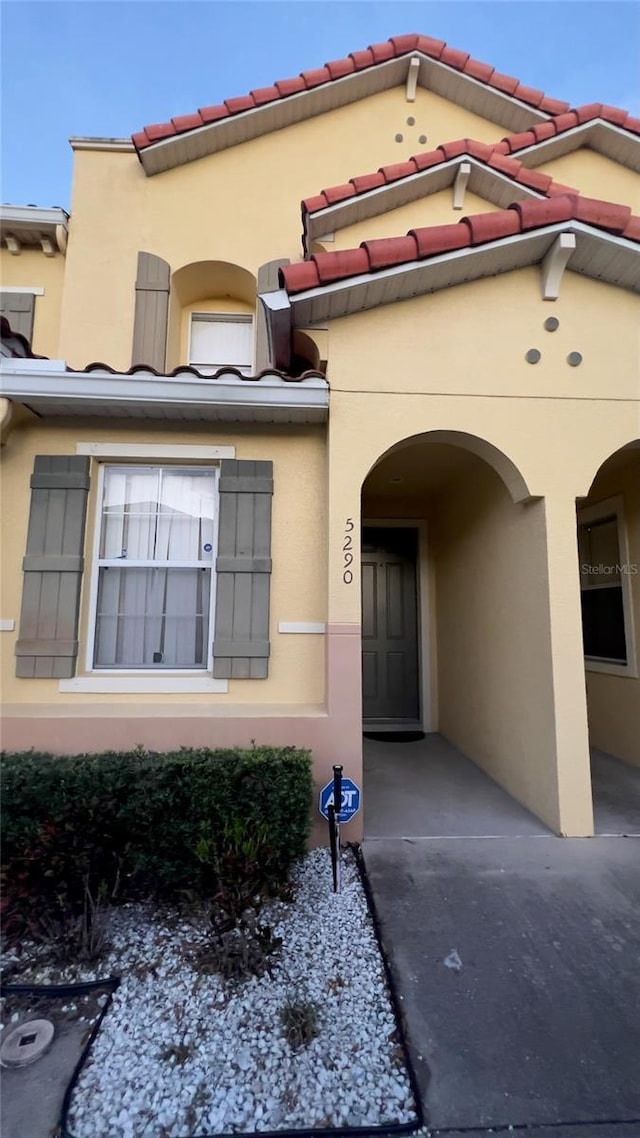 view of front of house featuring a tile roof and stucco siding