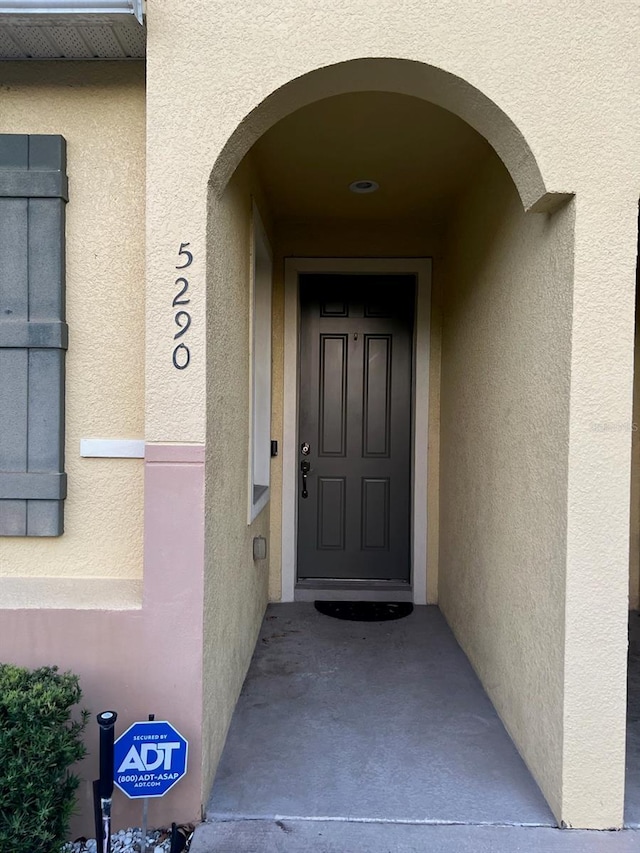 property entrance with stucco siding