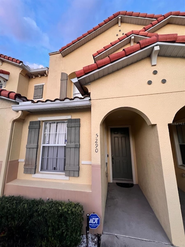 entrance to property featuring stucco siding