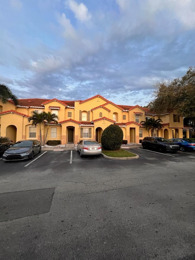 view of property featuring uncovered parking