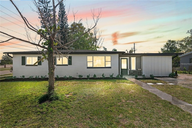 ranch-style house featuring a front lawn