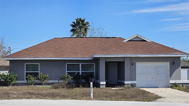 ranch-style home featuring a garage, driveway, a shingled roof, and stucco siding