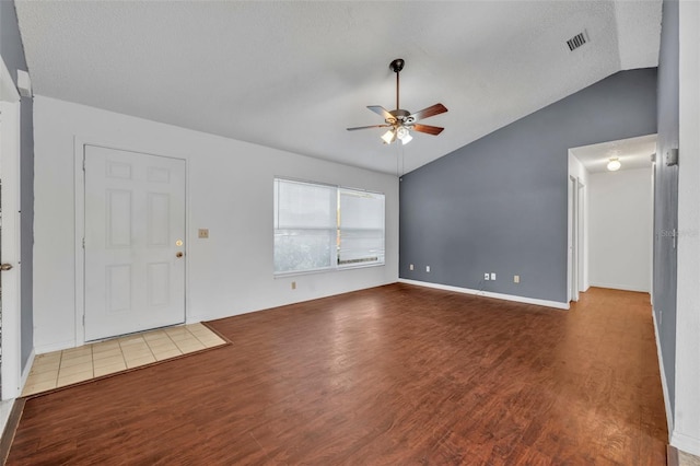 interior space featuring vaulted ceiling, wood finished floors, a ceiling fan, and visible vents