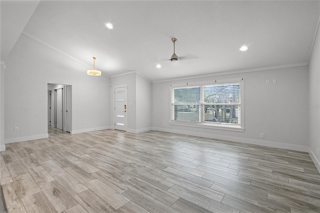 empty room featuring light wood-type flooring, baseboards, and crown molding