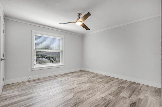 empty room featuring a ceiling fan, light wood-type flooring, and baseboards