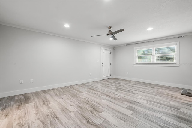 unfurnished room with a ceiling fan, light wood-style floors, and baseboards