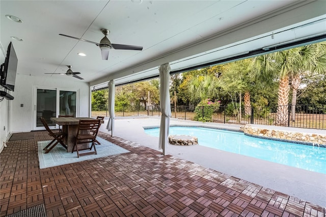 view of swimming pool with a patio area, a fenced in pool, a ceiling fan, and fence