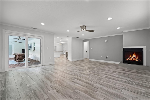 unfurnished living room featuring visible vents, light wood-style flooring, crown molding, and a ceiling fan