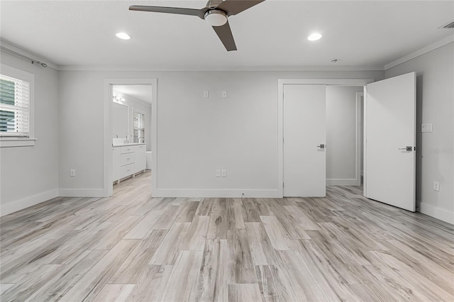 interior space with light wood finished floors, visible vents, crown molding, and baseboards