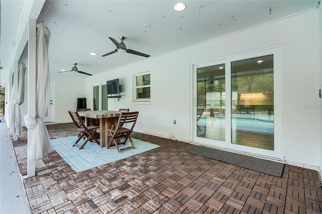 view of patio with outdoor dining area and ceiling fan