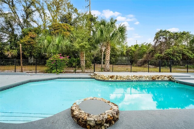 view of swimming pool with a fenced in pool and fence