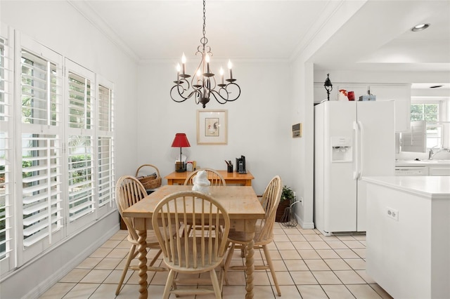 dining space featuring light tile patterned floors, baseboards, a chandelier, and crown molding