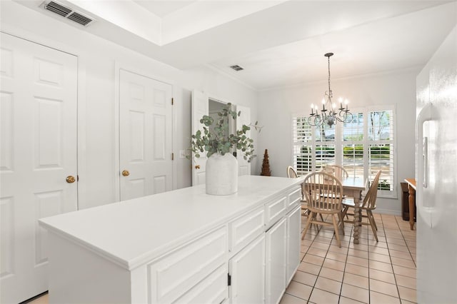 kitchen featuring visible vents, white cabinets, a notable chandelier, and light tile patterned flooring