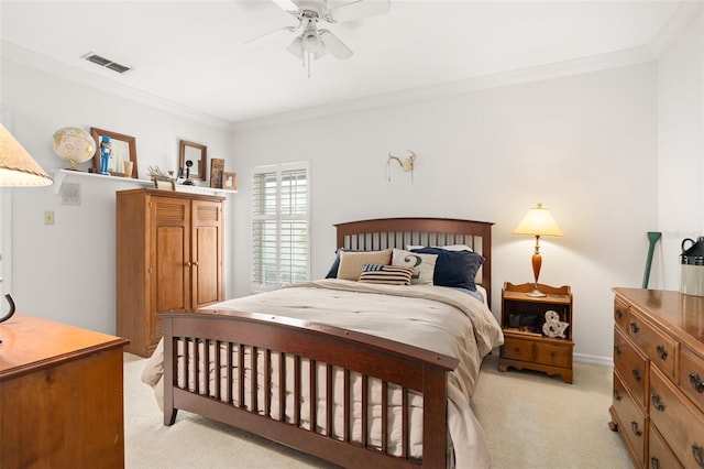 bedroom with ceiling fan, visible vents, crown molding, and light colored carpet