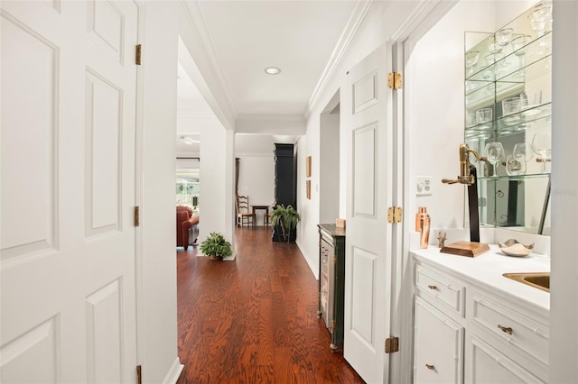 hallway featuring ornamental molding and dark wood finished floors