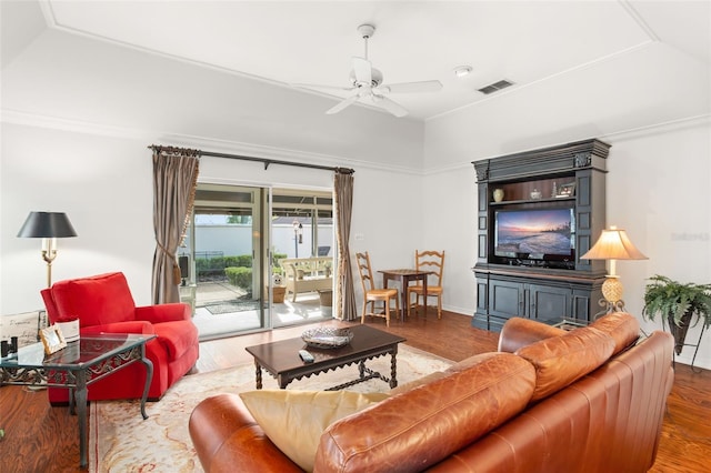 living area with a ceiling fan, visible vents, and wood finished floors