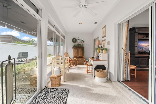 sunroom / solarium featuring ceiling fan and visible vents