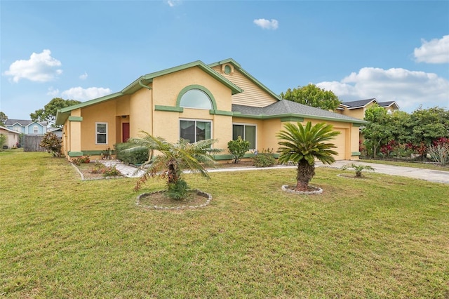 ranch-style house with a front yard, a garage, driveway, and stucco siding