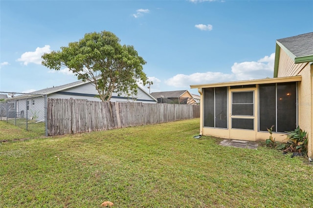 view of yard with fence and a sunroom