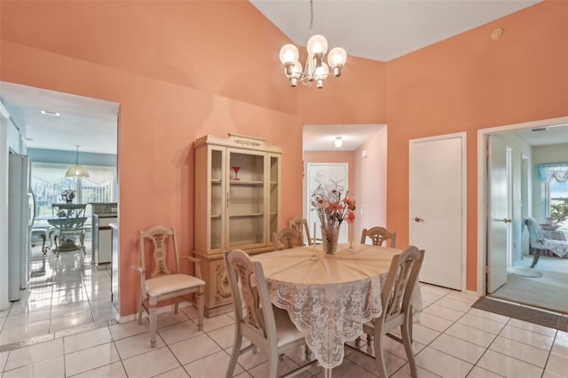 dining room with high vaulted ceiling, light tile patterned flooring, and a chandelier