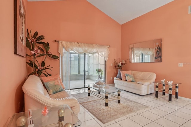 living room with tile patterned floors, visible vents, and high vaulted ceiling