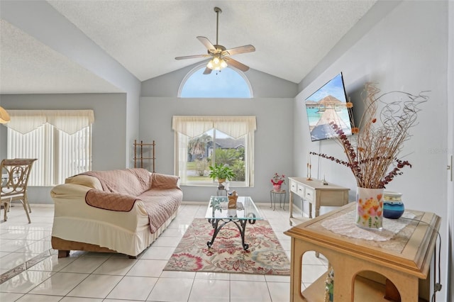 living room featuring light tile patterned floors, a textured ceiling, lofted ceiling, and a ceiling fan