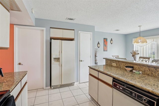 kitchen featuring decorative light fixtures, visible vents, white appliances, and light tile patterned flooring