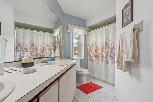 bathroom featuring tile patterned flooring, double vanity, toilet, and a sink